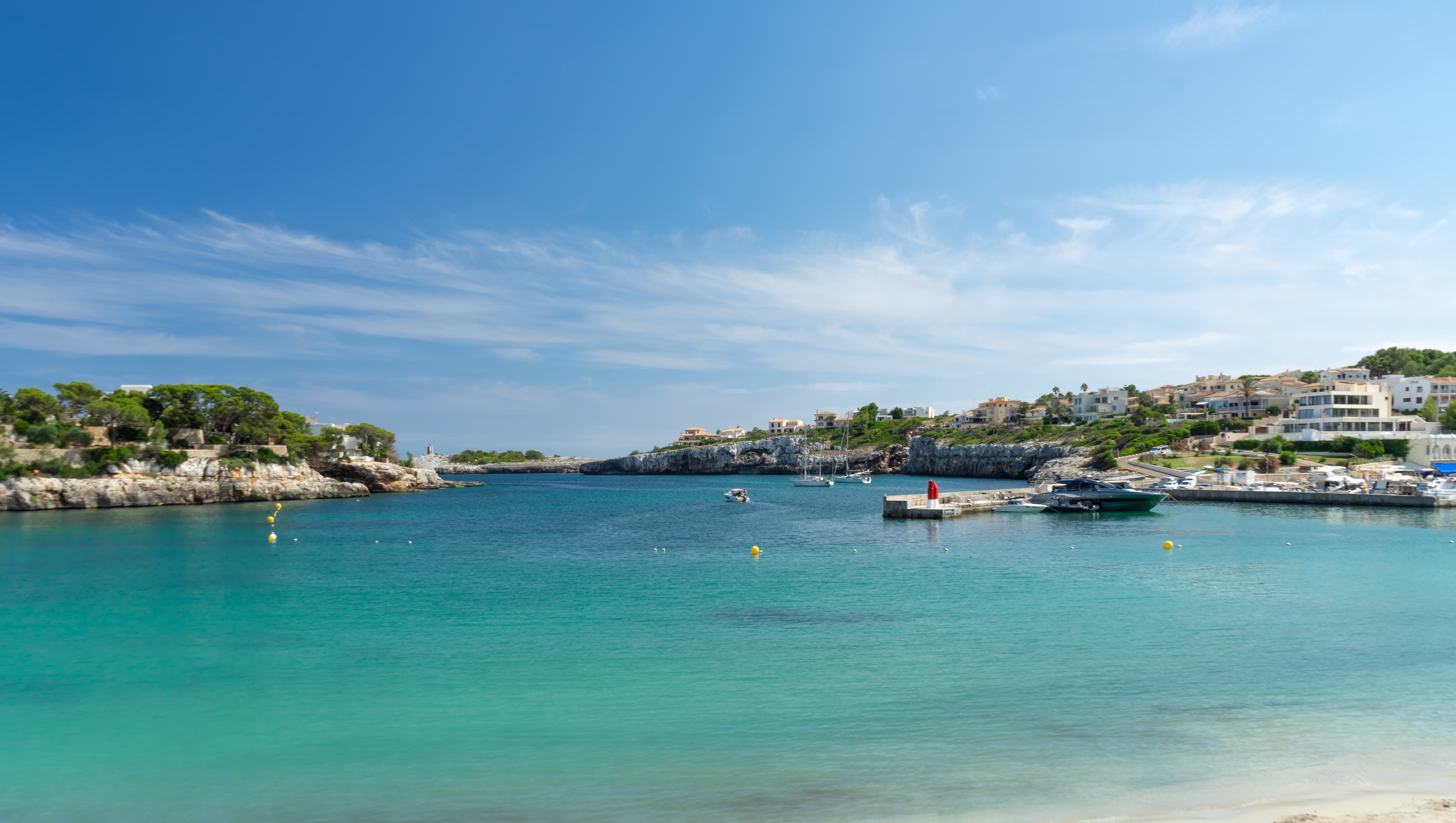 The small bay of Porto Cristo with a bathing beach and turquoise blue water The small bay of Porto Cristo with a bathing beach and turquoise blue water