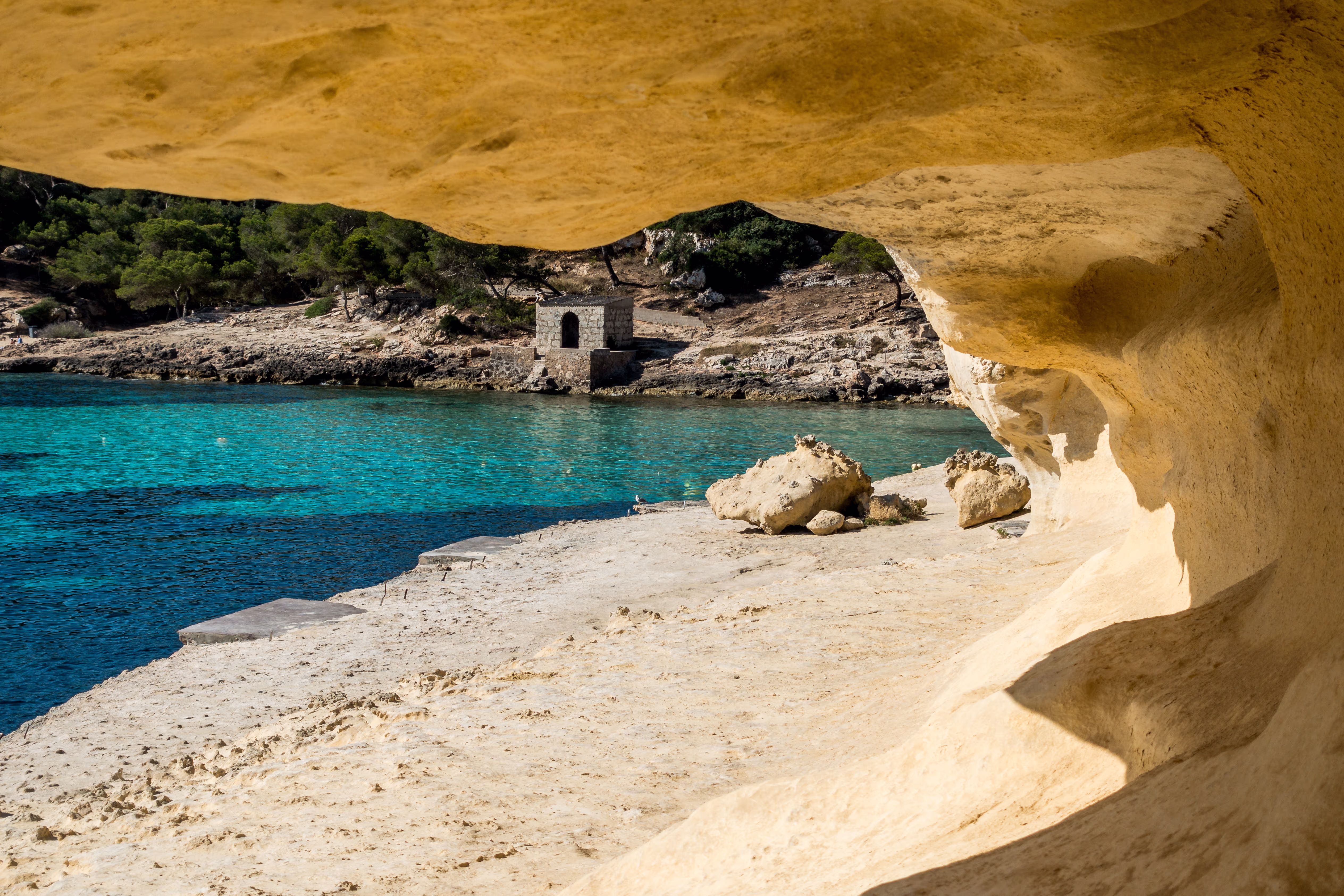 View through a limestone rock of the rocky coastline of Portals Vells View through a limestone rock of the rocky coastline of Portals Vells