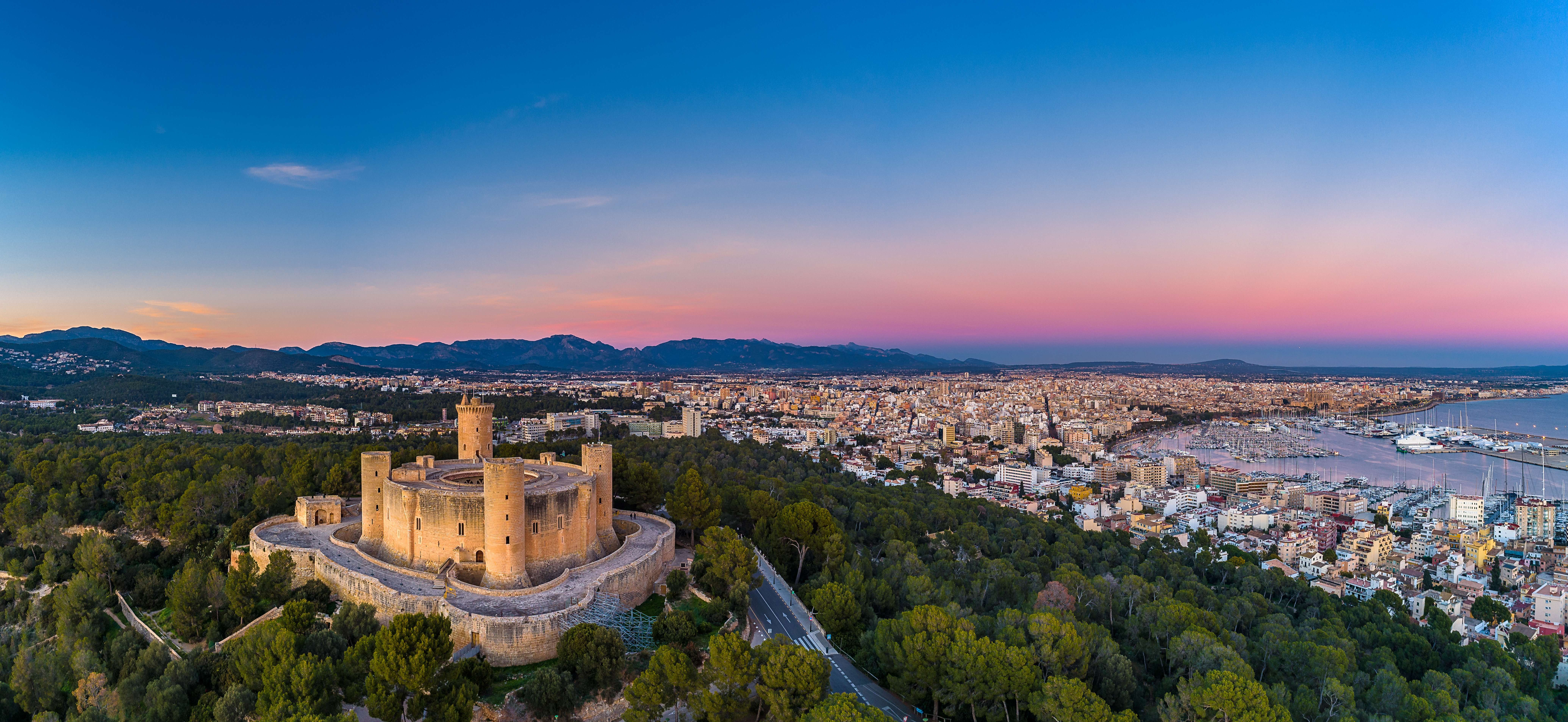 Castle, town and harbor on Mallorca at sunset