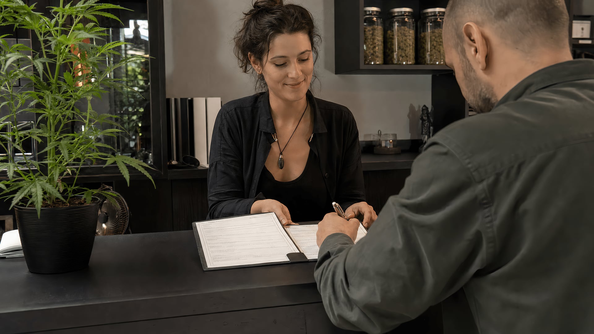 A receptionist checks membership forms at a cannabis social club in Palma.