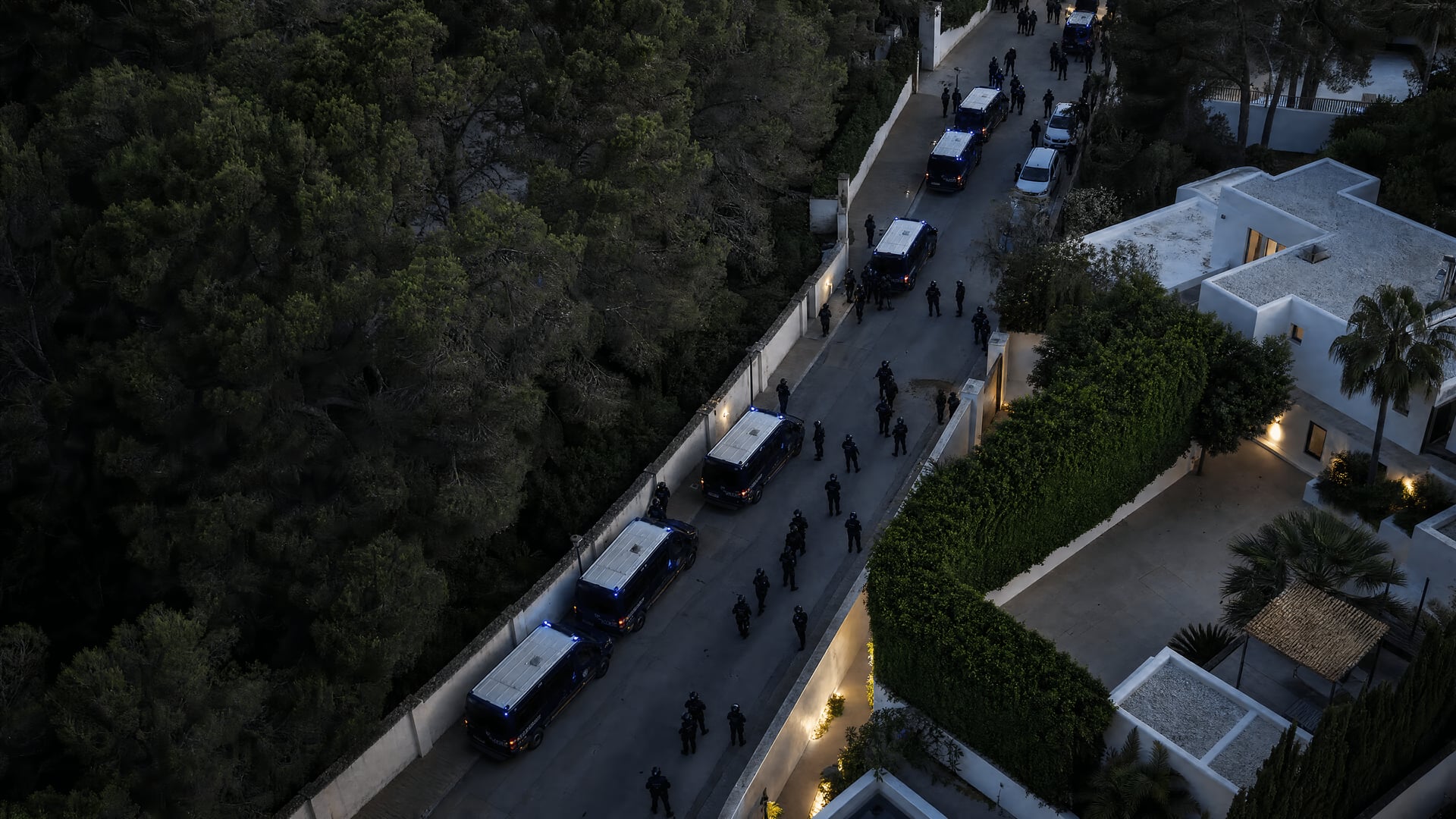 Police vehicles outside an Ibiza villa after an illegal party raid